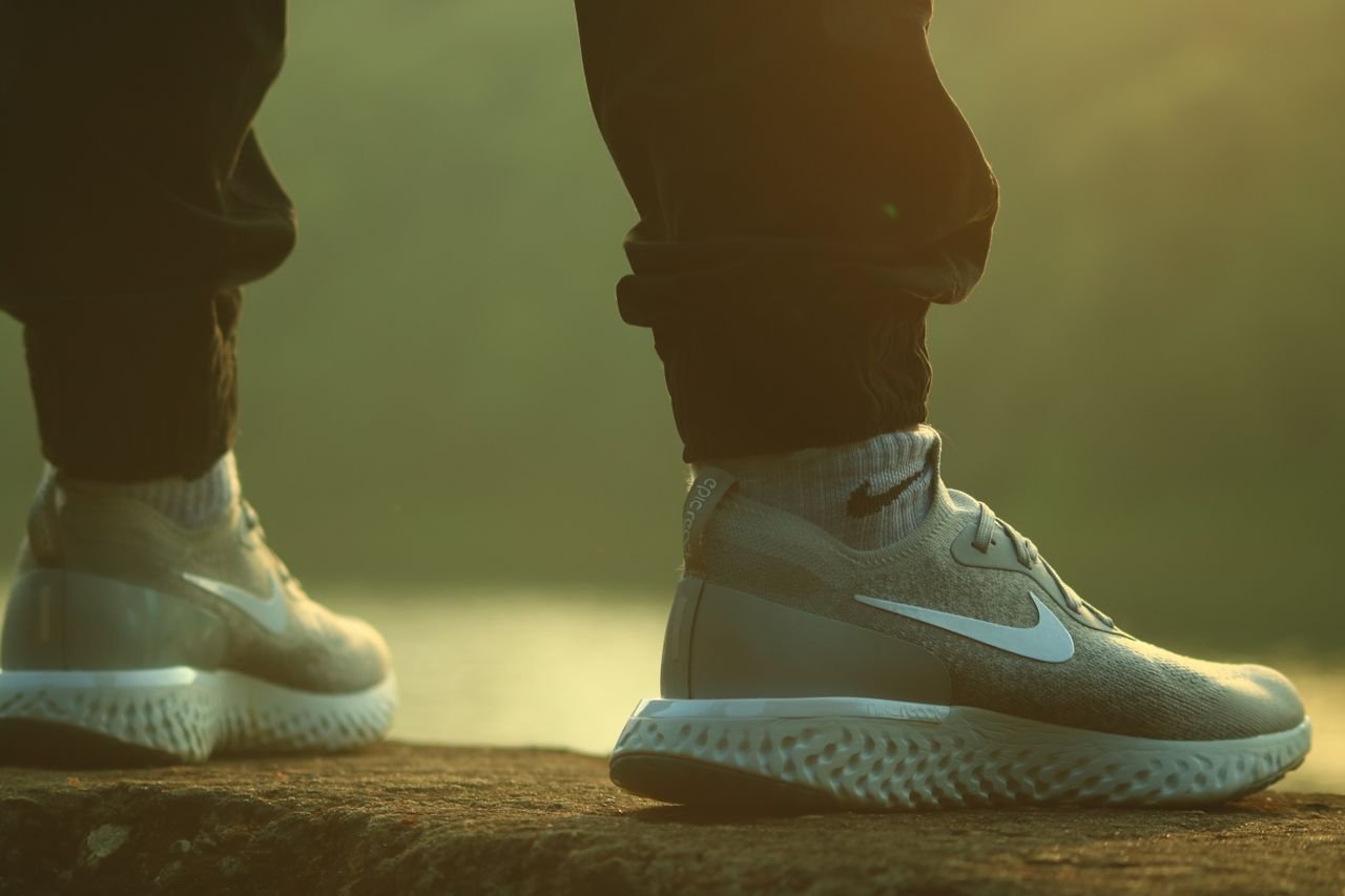 The Art of Drawing Readers In: Your attractive post title goes here Close-up of Nike sneakers on a person outdoors. Casual lifestyle fashion.
