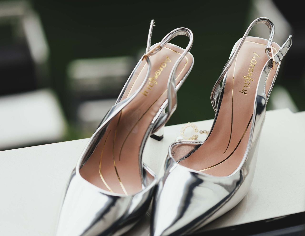 Services Close-up of shiny silver stiletto heels, perfect for wedding occasions and formal events.
